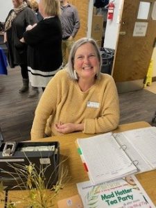Amy taking attendance and helping our guests at the Middle School Writing and Poster Contest breakfast